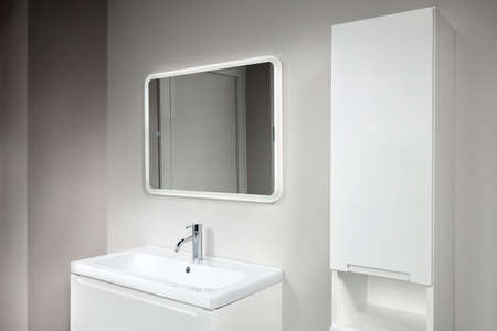 Stoneware countertop bathroom with tired beton wall . White industrial flat loft bathroom with modern countertop basin, square mirror and PVC cupboard.の写真素材