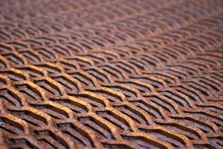 Perforated rusty metal sheet stamping plates texture closeup angled view. Made through metal stamping sheet metal manufacturing lightweight bearing elements structural combine strength functionality.の写真素材