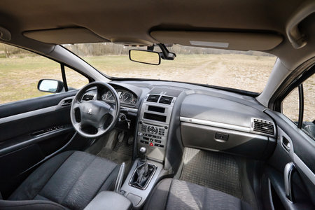 Berlin - April 2014: Peugeot 407 2003-2010 sedan pre facelift interior dashboard cockpit steering wheel front seat and mechanic manual transmission gearbox.のeditorial素材