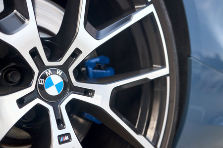 Berlin - August 2022: BMW 8 Series xDrive M-pack car closeup alloy wheel with low profile tires side view with m-pack and bmw logos.のeditorial素材