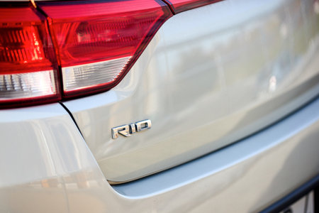 Berlin - October 2021: grey metallic sedan car 2017 Kia Rio IV Sedan YB fourth generation back side chrome emblem sign logo close upのeditorial素材