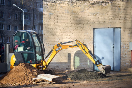 Grodno - November 2021: JCB 8018 CTS excavator digging sand and concrete at construction site. JCB mini excavator belongs to smallest machine segment in mini excavators category.のeditorial素材