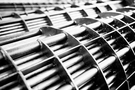 Heat exchanger tube bundle of industrial heat exchangers shell and tube condenser, made of steel black and white BW high contrast selective focus shot. Abstract industrial heat exchanger background.の写真素材