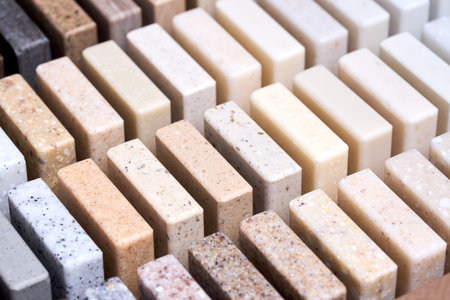 Porcelain stoneware square samples as kitchen countertop examples of future kitchen fasade exterior. Samples slabs of natural granite marble quartz for stone countertops close up.の写真素材