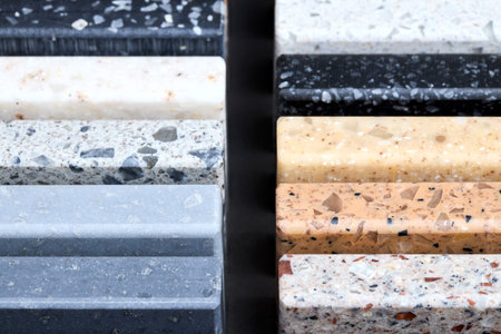 Porcelain two symmetrical groups stoneware samples as kitchen countertop examples of future kitchen fasade exterior. Samples slabs of natural granite marble quartz for stone countertops close up.の写真素材