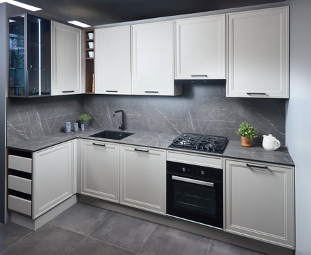Interior of white and grey kitchen, horizontal, linear layout. Luxury modern fitted flat design kitchen with glass elements.の写真素材