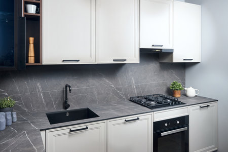 Interior of white and grey kitchen, horizontal, linear layout. Luxury modern fitted flat design kitchen with glass elements.の写真素材