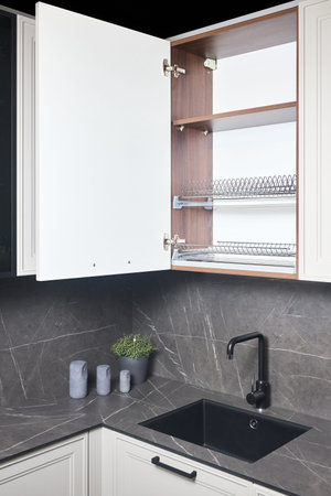 Interior of contemporary kitchen. Luxury modern fitted flat design kitchen with opened cupboard shelves sideboard with dish drying cabinet.の写真素材