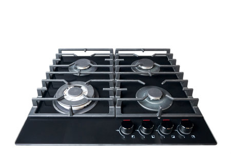 Contemporary black tempered glass gas stove hob with wok burner with auto ignition knob cast iron pan supports and flame safety valve built in isolated on white.の写真素材