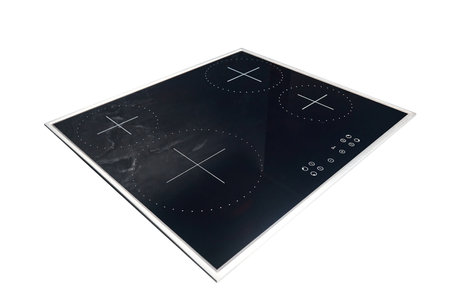 Flat cooktop cooking induction electric built black stove. Electric induction hob with ceramic tempered glass surface with white burners and touch control buttons panel isolated on white.の写真素材