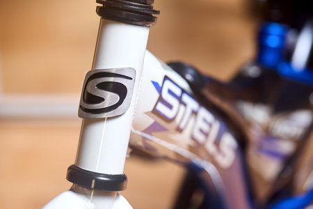 Berlin - May 2023: children bicycle Stels ergonomic Fragment of head tube, top part of fork with logo closeup selective focus shot.のeditorial素材