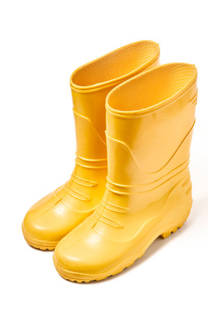 Pair of yellow rubber boots for kids isolated on white backgroundの写真素材
