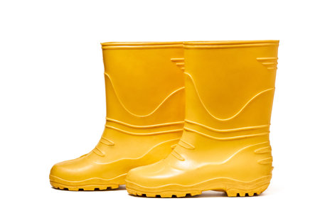 Pair of yellow rubber boots for kids isolated on white background side view.の写真素材