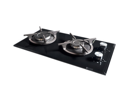 Contemporary black tempered glass gas stove hob with Two burners with auto ignition knob cast iron pan supports and flame safety valve isolated on white background.の写真素材