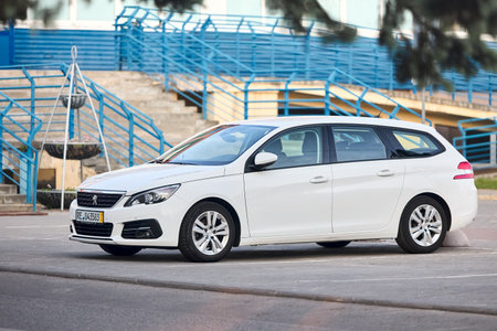 Berlin - May 2023: 2021 Peugeot 308 SW station wagon version of 308 compact family car produced by French auto manufacturer PSA left side view outdoors parked on street.のeditorial素材
