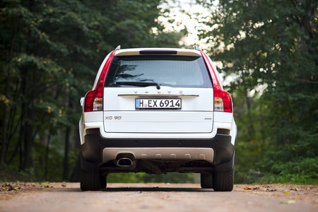 Berlin, Germany - October 3, 2023: Volvo XC90 4.4 v8 1st generation restyling 4WD SUV test drive in spring country road on forest background back view.のeditorial素材