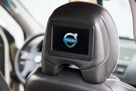 Berlin, Germany - October 3, 2023: Volvo XC90 4.4 v8 1st generation restyling 4WD SUV Car inside headrest screen. Interior of prestige luxury modern car, back seats passenger display with Volvo logo.のeditorial素材