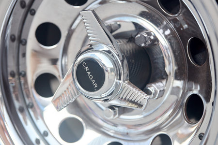 Berlin, Germany - August 20, 2022: Muscle car detail closeup nickel plated alloy wheel side view...