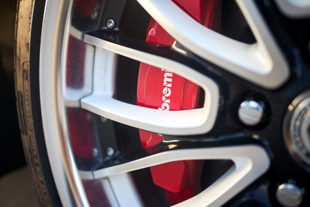 Berlin, Germany - August 20, 2022: Car detailing. Aluminum wheels with Red Brembo Brake Calipers...