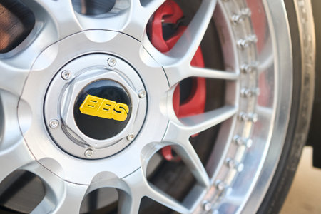 Berlin, Germany - August 20, 2022: BBS badges logo emblem on BBS alloy wheel plug and red brake caliper selective focus close up.のeditorial素材