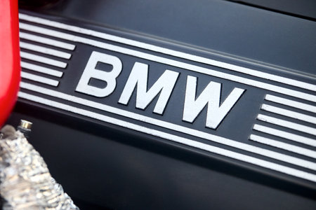 Berlin, Germany - August 20, 2022: Car Detail Shot of BMW E28 M5 1984-1988 BMW logo emblem into engine bay on decorative engine cover selective focus closeup.のeditorial素材