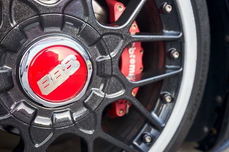 Berlin, Germany - August 20, 2022: BBS badges logo emblem on BBS alloy wheel plug and red brake caliper selective focus close up.のeditorial素材