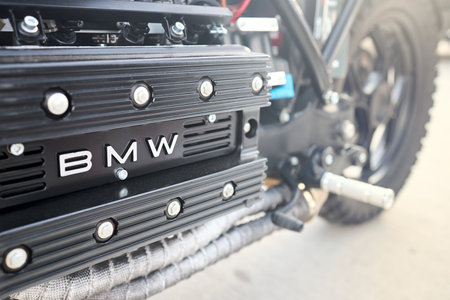 Berlin, Germany - August 20, 2022: Bike Detail Shot of BMW K 1100 logo emblem on engine valves and crankshaftcover footrest and wheel selective focus closeup.のeditorial素材