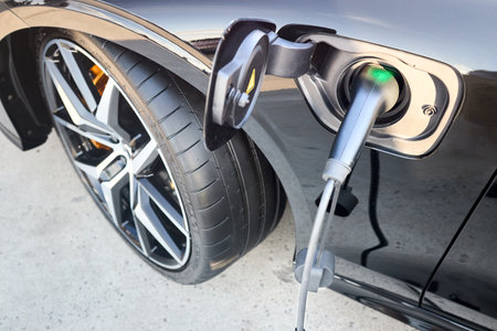 Berlin, Germany - August 20, 2022: 3rd generation Volvo V60 T8 PoleStar eAWD Electric hybrid car charge on charging station closeup view.のeditorial素材