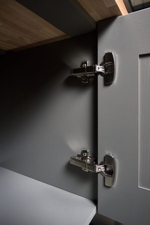Hinge cabinet of kitchen moss grey cupboard door metal furniture isolated under ash wood countertop...