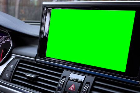 Monitor in car isolated blank screen for navigation maps and GPS rearview camera and parking assistant. Car display with blank green screen for design mock up, copy space.の写真素材