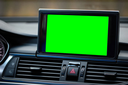 Monitor in car isolated blank screen for navigation maps and GPS rearview camera and parking assistant. Car display with blank green screen for design mock up, copy space.の写真素材