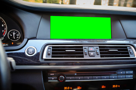 Monitor in car isolated blank screen for navigation maps and GPS rearview camera and parking assistant. Car display with blank green screen for design mock up, copy space.の写真素材