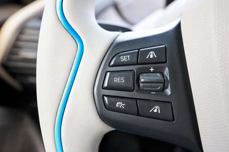 Berlin, Germany - May, 4 2024: BMW i3 Range Extender REx. Steering wheel left control buttons Store speed, Resume speed, Cruise control, Active Cruise Control adjusting and switching, rocker switch.のeditorial素材