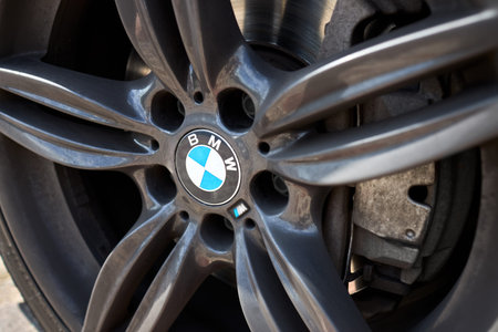 Berlin, Germany - August 05, 2024: BMW M Series xDrive M-pack car closeup alloy wheel with low...