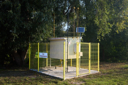 Natural gas regulatory and distribution point with solar battery near forest sunny day. Gas delivery to consumer cabinet. Russian text - flammable gas.の写真素材