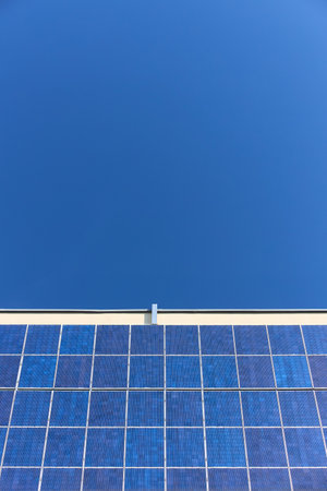 Many solar panels texture with copyspace vertical shot. Building with lots of solar panels. Renewable solar energy. Alternative Generator Energy efficient house uses solar energy of sunの写真素材