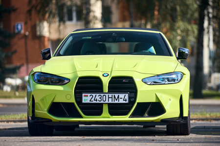 Minsk, Belarus - September, 18 2024: Brand new BMW M4 G82 Competition 2020-present, manufactured and marketed by BMW parked over urban backgroundのeditorial素材