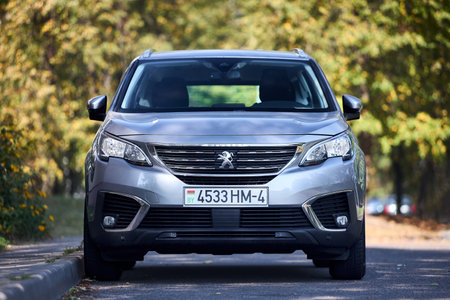 Minsk, Belarus - September, 18 2024: Peugeot 5008 Second generation P87 2017-2024 parked over urban background.SUV, parked.のeditorial素材