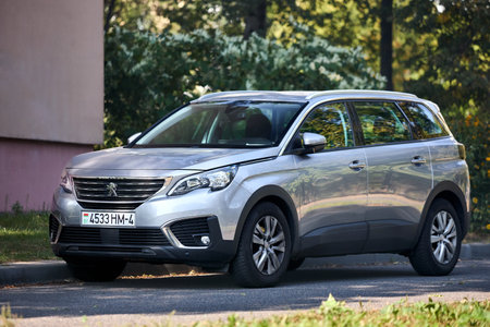 Minsk, Belarus - September, 18 2024: Peugeot 5008 Second generation P87 2017-2024 parked over urban background.SUV, parked.のeditorial素材
