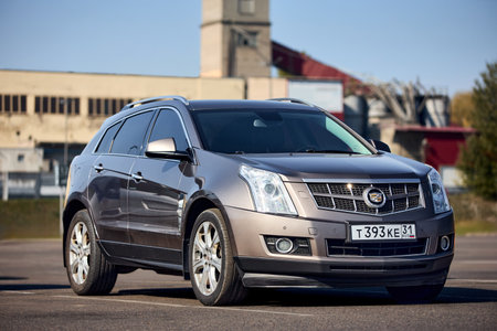 Minsk, Belarus - September, 18 2024: Luxury crossover second generation mid-size SUV Cadillac SRX 4 II parked over urban background.のeditorial素材