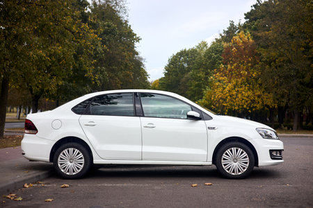 Minsk, Belarus - September, 26 2024: white Volkswagen Polo Sedan I, compact sedan car parked, side view.のeditorial素材