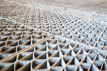 Metal industry steel grade sheet or floor grating with multicolored drops of paint macro closeup. Shallow depth of field diminished perspective industrial grates profiled drainage latticed flooring.の写真素材