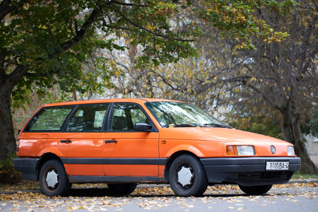 Minsk, Belarus - October, 22 2024: Volkswagen Passat B3 GT OLrange Metallic universal selective focus side three quarter view outdoors in autumn urban background.のeditorial素材