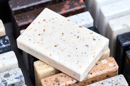 Porcelain stoneware square samples as kitchen countertop examples of future kitchen fasade exterior. Samples slabs of natural granite marble quartz for stone countertops close up.の写真素材