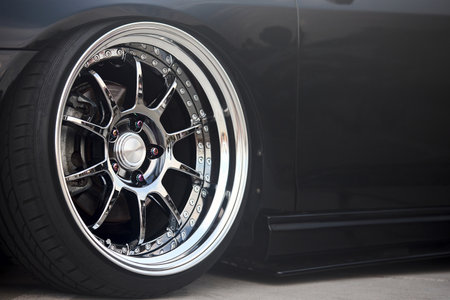 Sport car front wheel tire Rim detailing with gray brake calipers selective focus automotive shot with copyspaceの写真素材