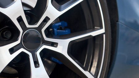 Car detailing closeup alloy wheel with tires and blue calipers side view 16x9 shotの写真素材