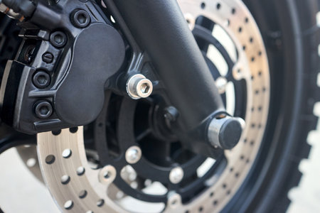 Front disc brakes bike closeup. Front radial mount caliper bike, Motorcycle with Twin Floating Disk Brake and ABS system with copyspace.の写真素材