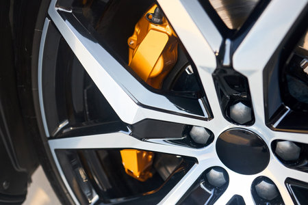 Alloy wheel plug and golden yellow brake caliper selective focus close upの写真素材