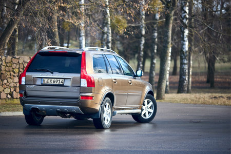 Berlin - October 2021:: Volvo XC90 2.5 1st generation Twilight Bronze 2002-20014 restyling 4WD 4wheel 4x4 SUV at spring forest road back three quarter view in the evening, with copyspace.のeditorial素材