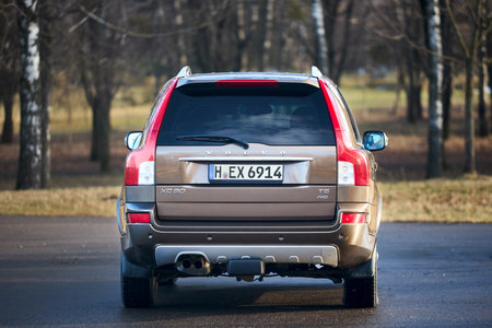 Berlin - October 2021:: Volvo XC90 2.5 1st generation Twilight Bronze 2002-20014 restyling 4WD 4wheel 4x4 SUV at spring forest road back view in the evening, with copyspace.のeditorial素材